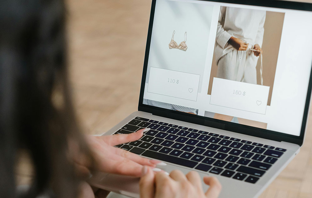 woman looking at a website on a laptop