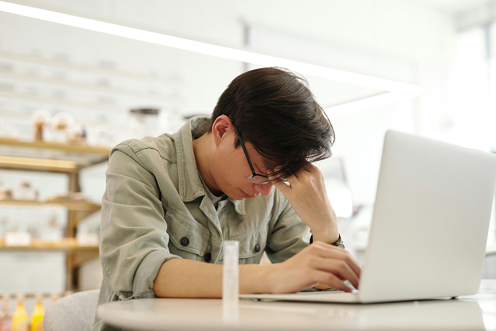 frustrated man using a laptop