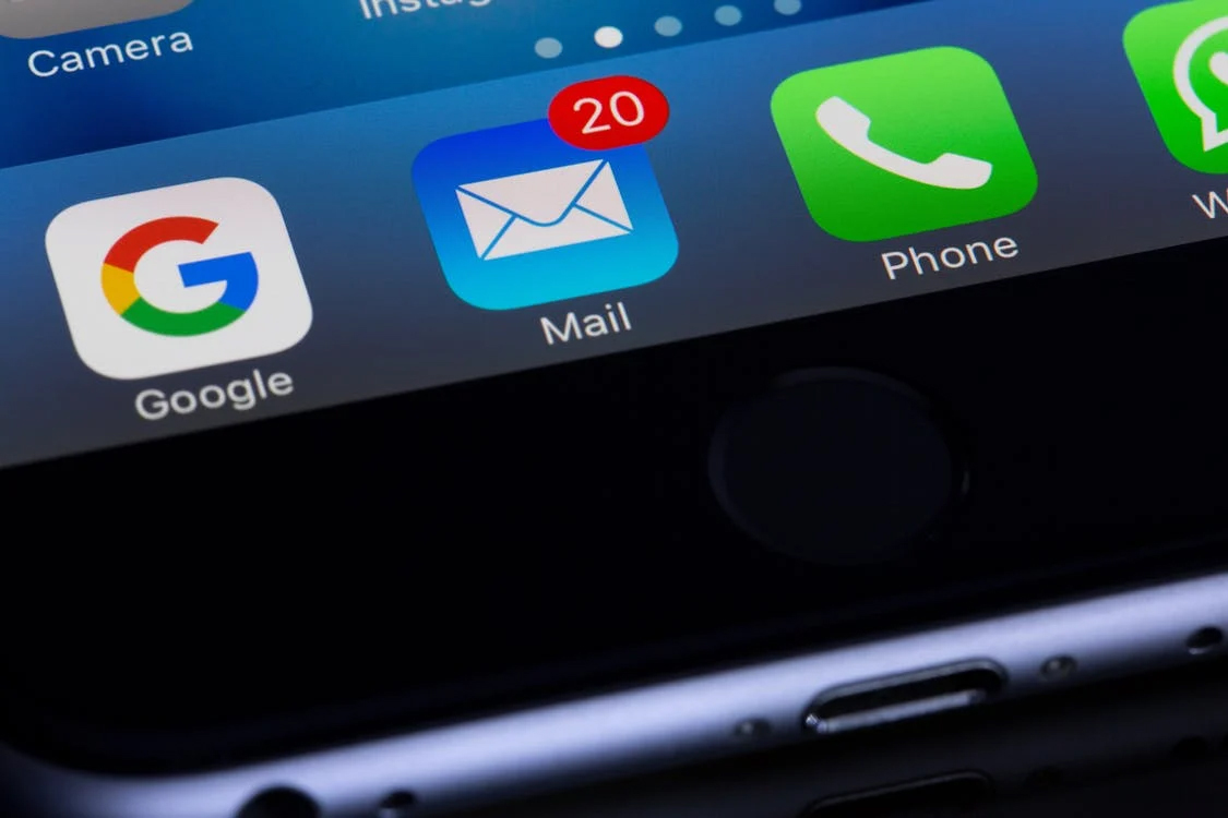 the google, mail, and phone apps close up on an iphone