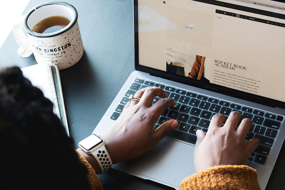 woman looking at a website on a laptop