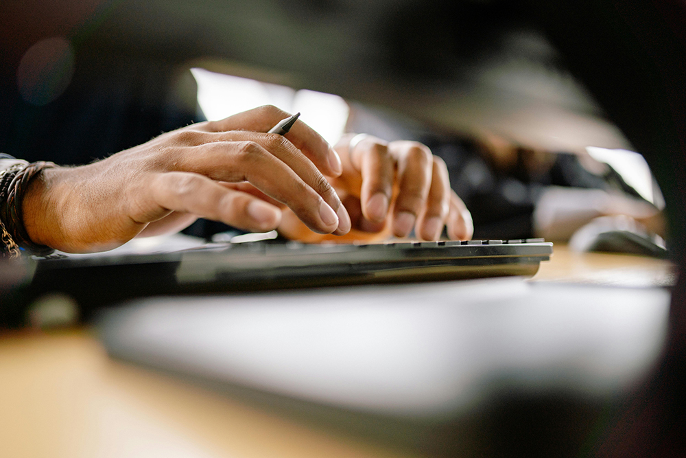 someone typing on a computer keyboard