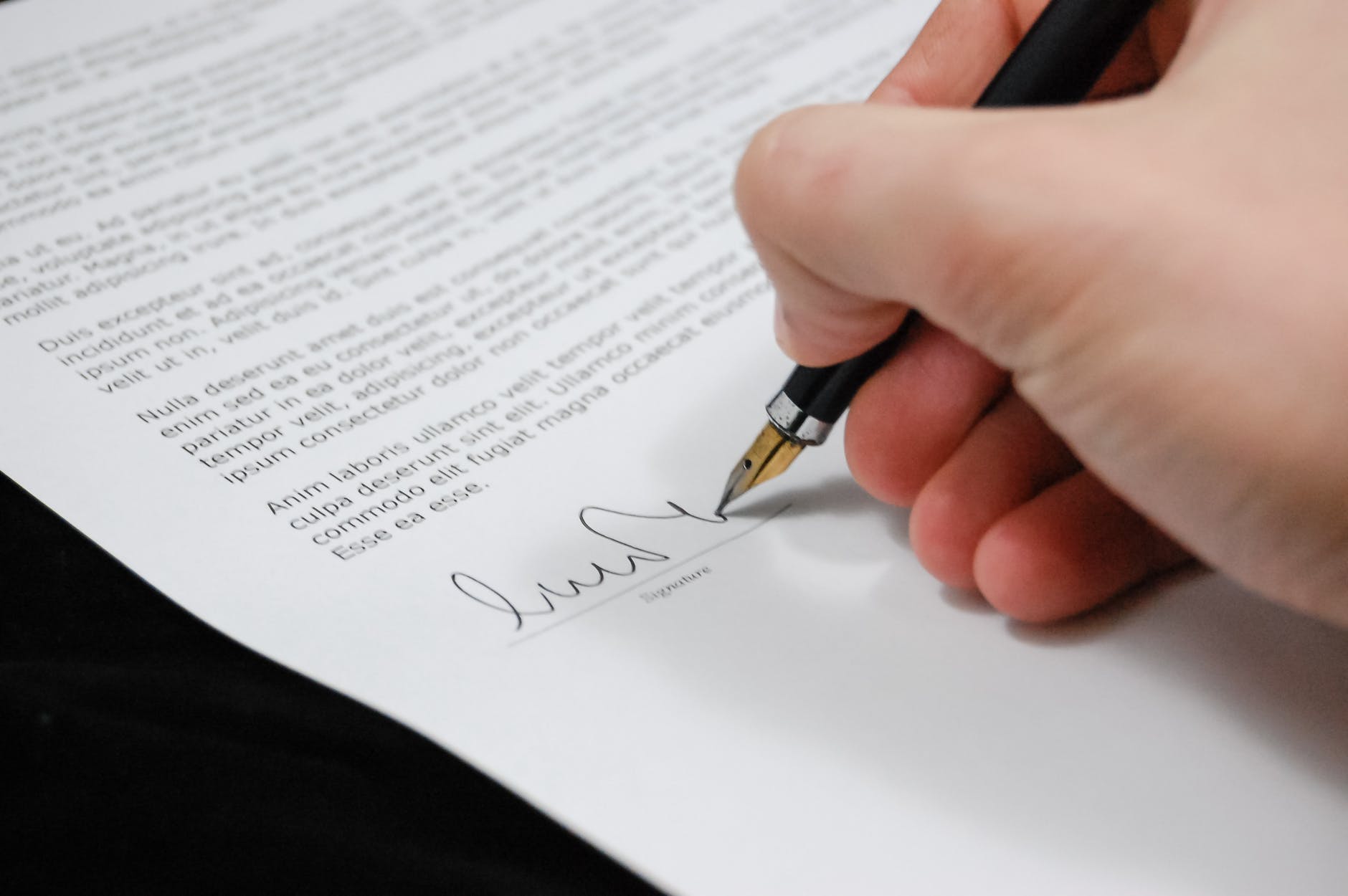 someone signing their name on a legal document