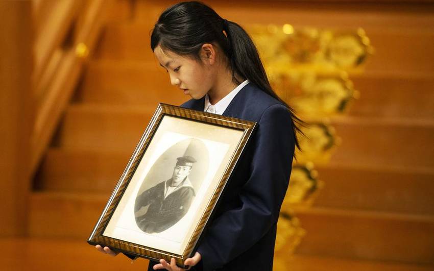 Akari Terahara, 11, holds a ph...